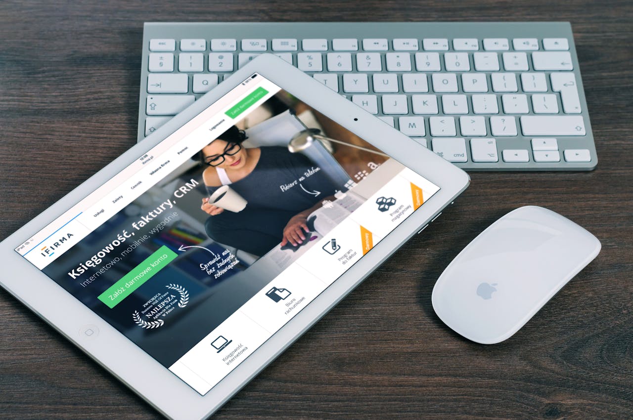 gallery-1 A tablet with a financial website open, alongside a white keyboard and mouse. Ideal for tech-theme stock images.